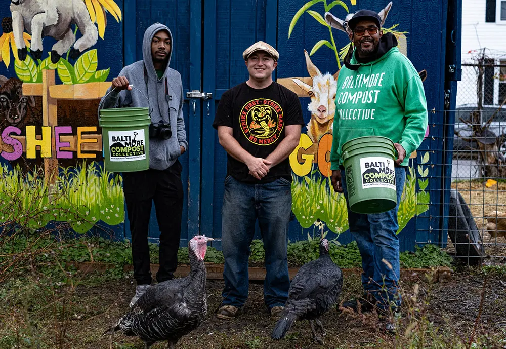 Baltimore Compost Collective members holding buckets