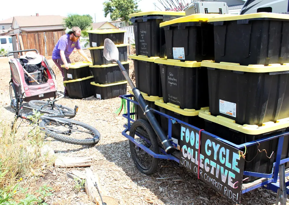 Food Cycle Collective with containers of compost