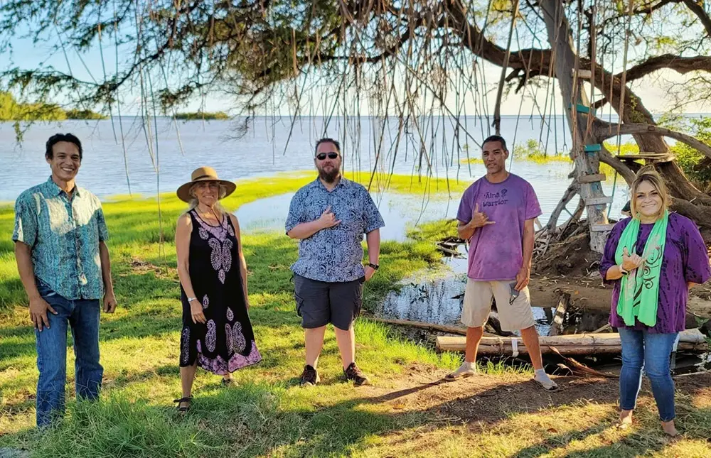 Ho ahu Energy Cooperative members in front of the ocean