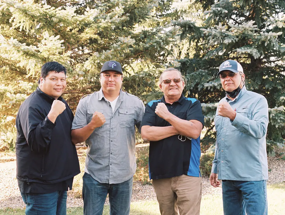 Indigenous Energy Initiative members in front of a grove of trees