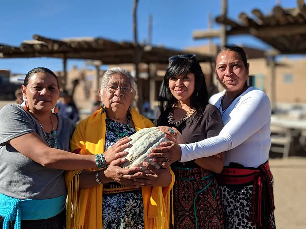 Indigenous Seedkeepers Network members holding produce