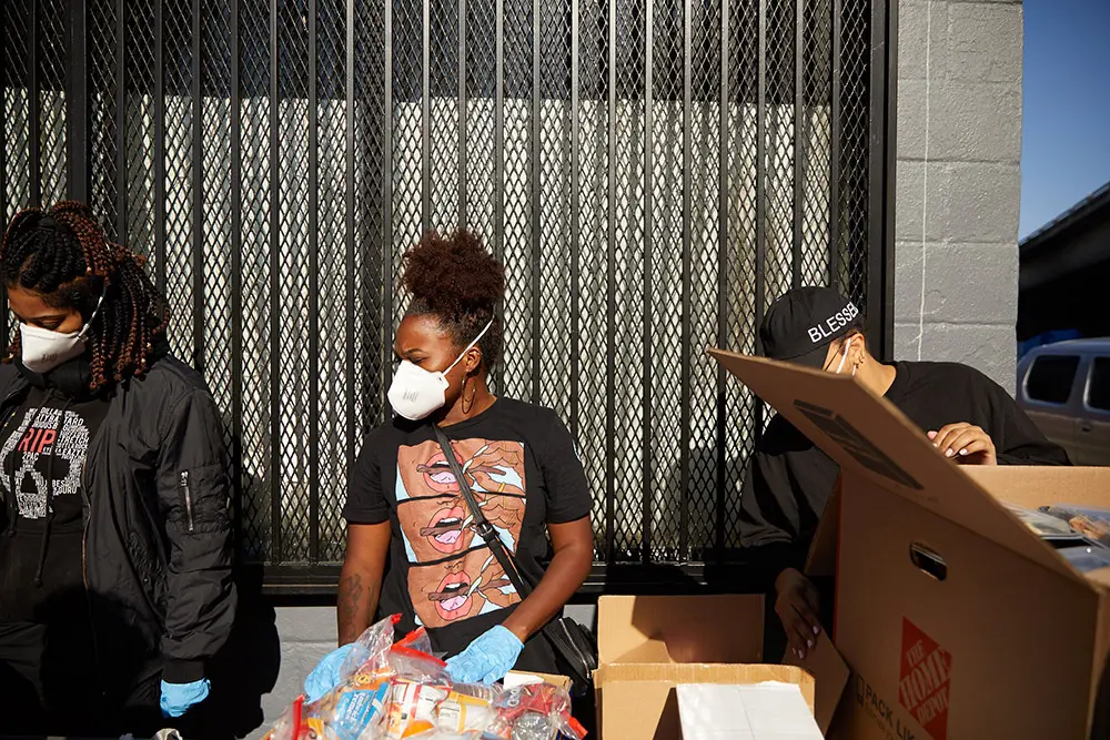 People's program members handing out bags of food