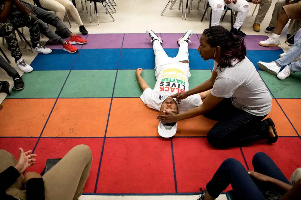 Ujimaa Medics member teaching live saving techniques